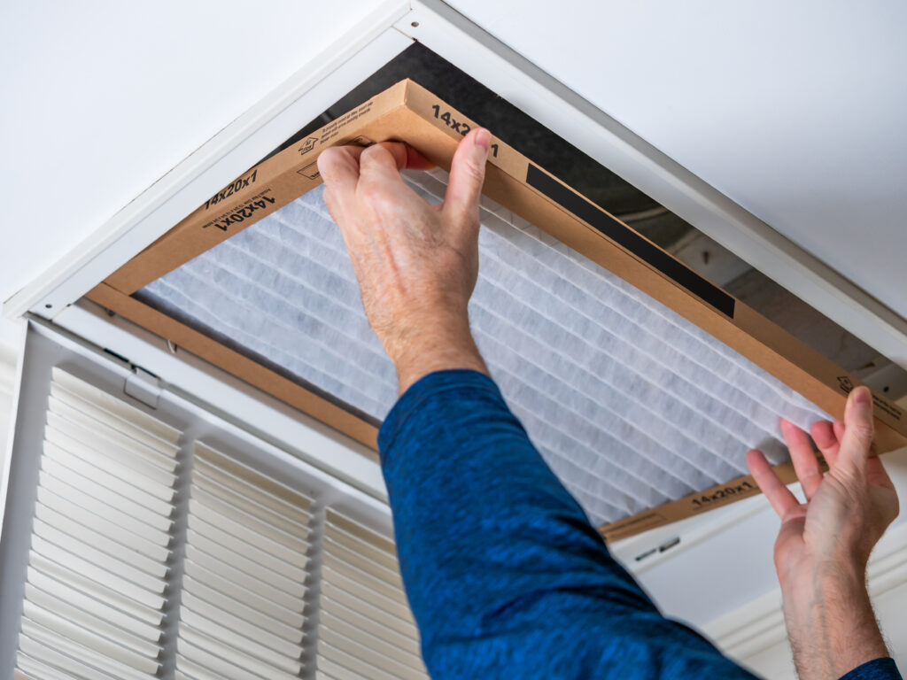 HVAC technician replacing a home air filter in Diamond Bar