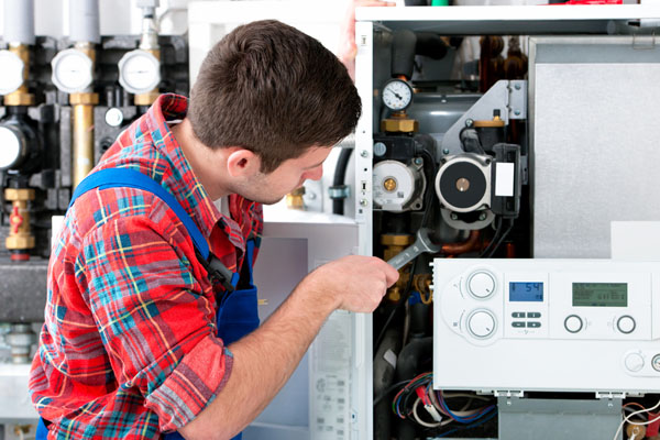 Heating technician repairing boiler controls in Diamond Bar