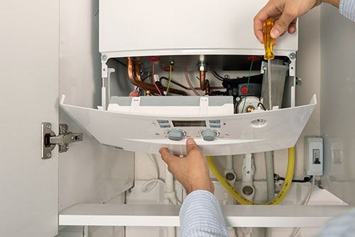 Heating technician repairing a residential boiler in Diamond Bar