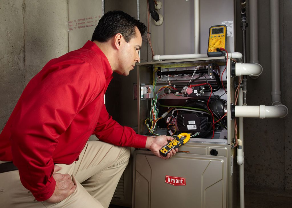 Heating technician diagnosing a furnace repair in Diamond Bar