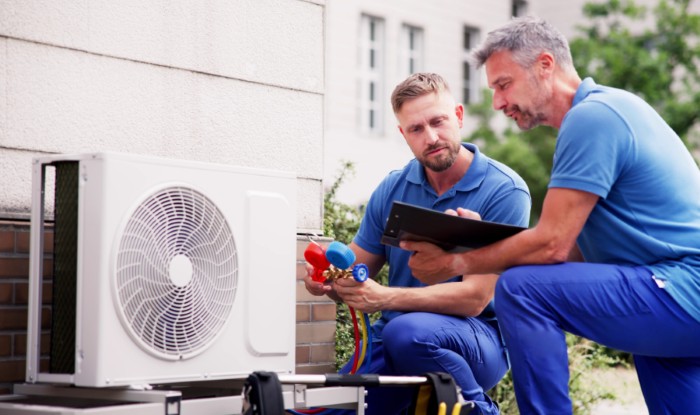 HVAC technicians installing an outdoor air conditioning unit in Diamond Bar